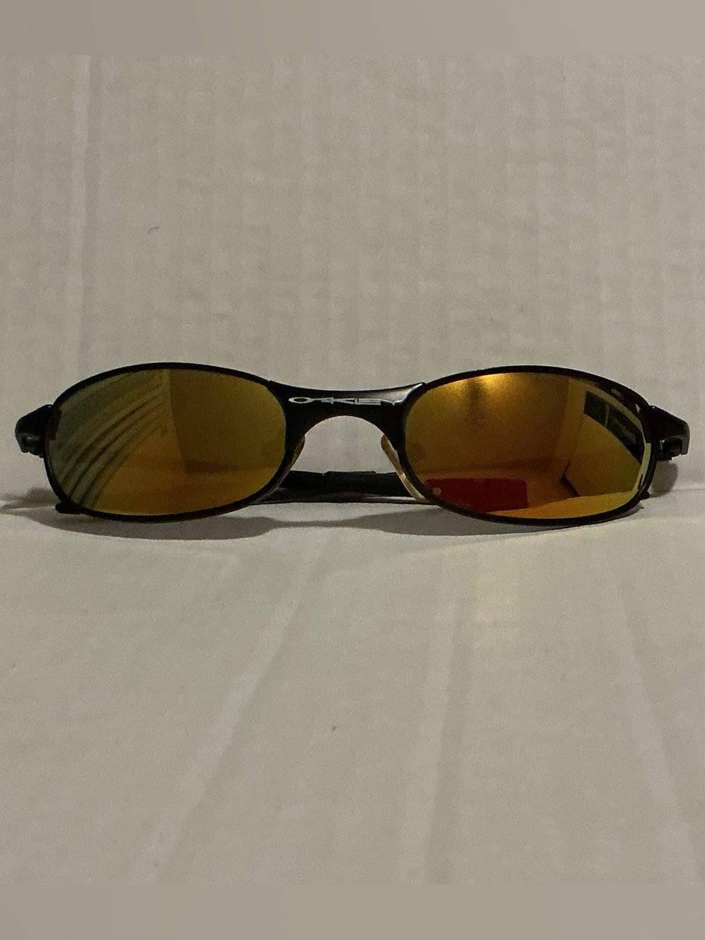 Oakley Men’s Black Frame Sunglasses with Gold-Orange Mirror Lenses